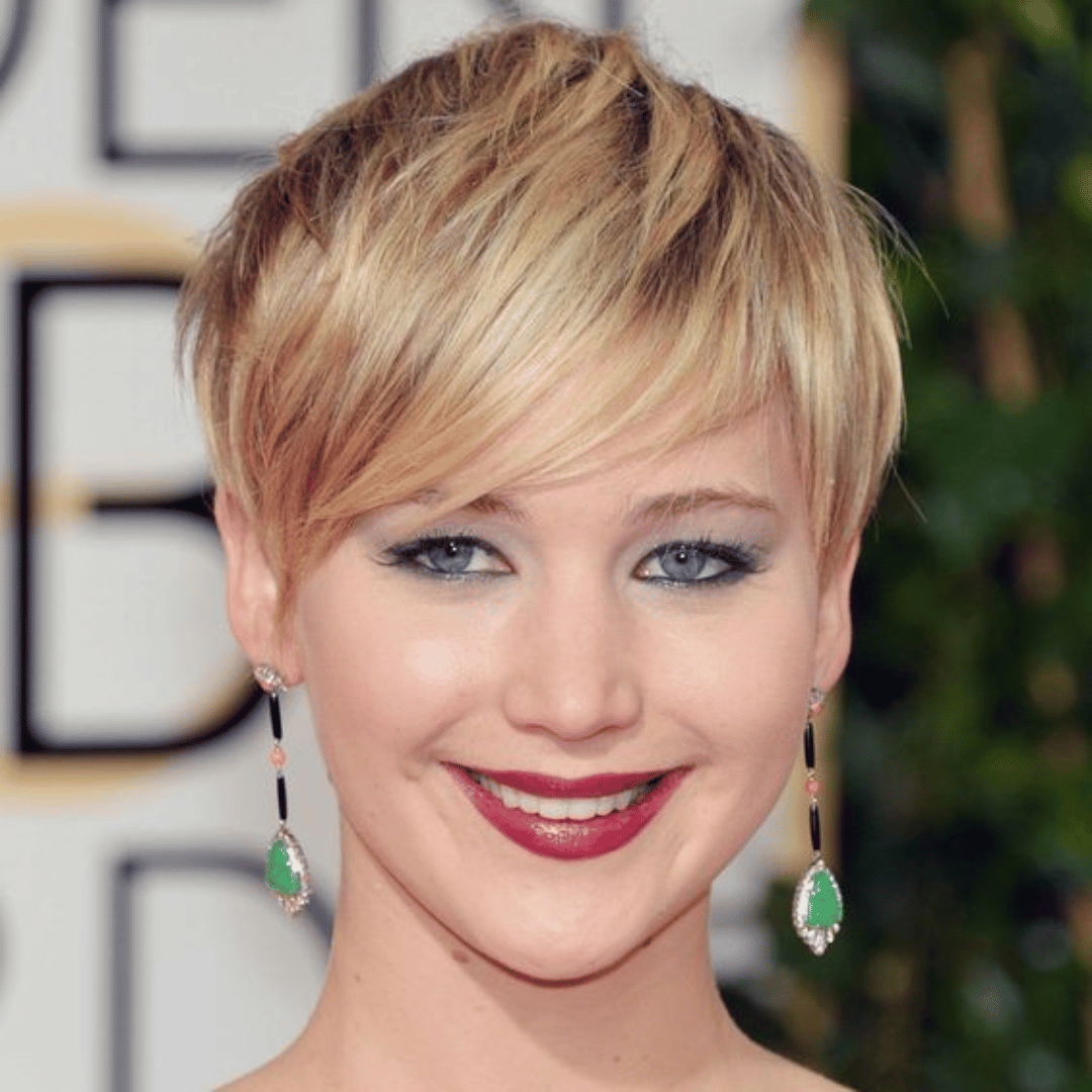 Woman with a pixie cut highlighting her heart-shaped face features.